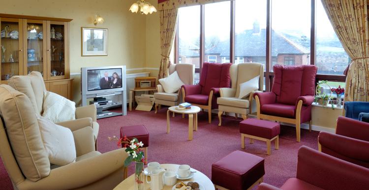 care home lounge with sofas and television